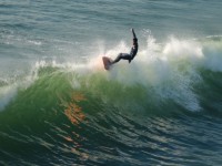 Longboard Surfer On The Wave Crest