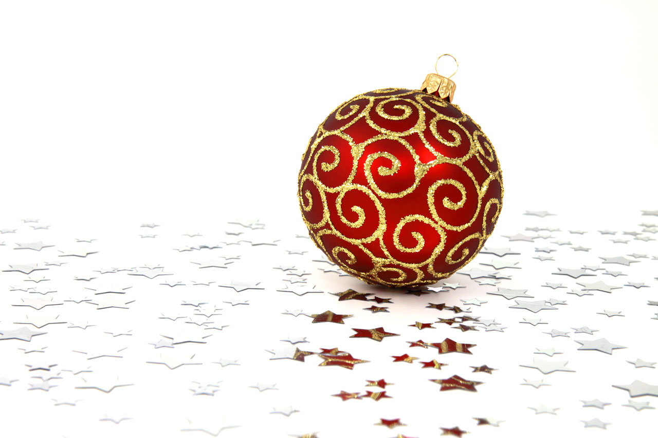 A red Christmas bauble with silver stars