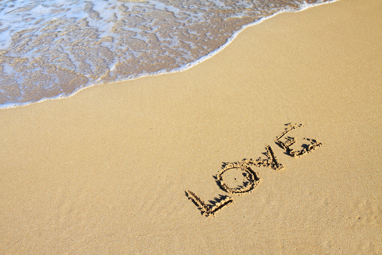 word love in sand on beach