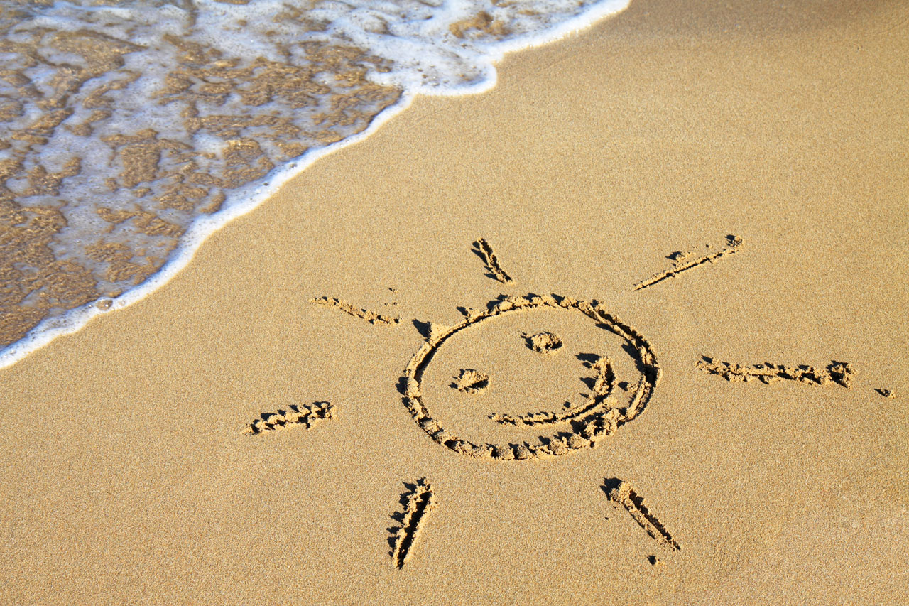 sun sign in sand on beach