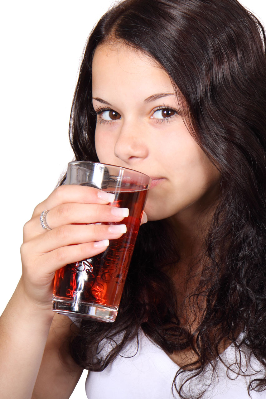 young woman drinking a glass of juice