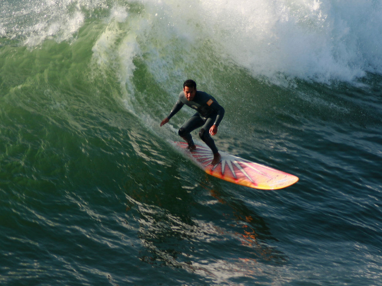 Longboard Surfer Drops In On A Wave