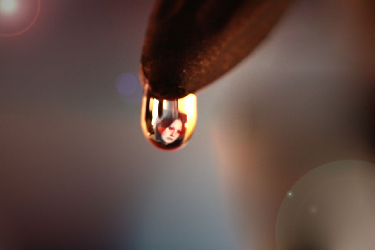 My favorite photograph of my wife refracted in a drop of water. She passed away on the 4th of November, at the age of 23. I miss her so much....