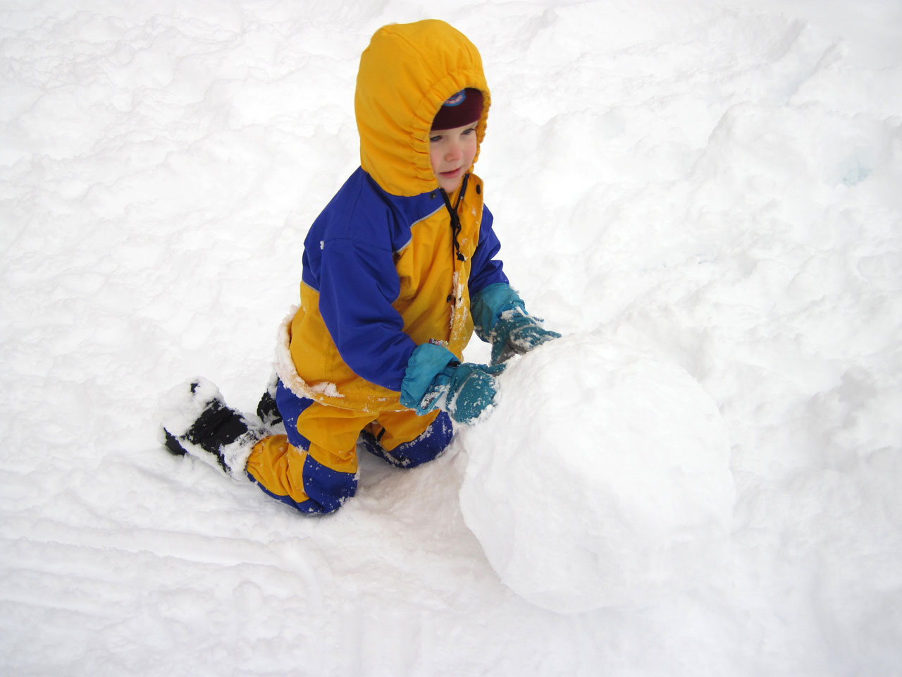 child making a huge snowball