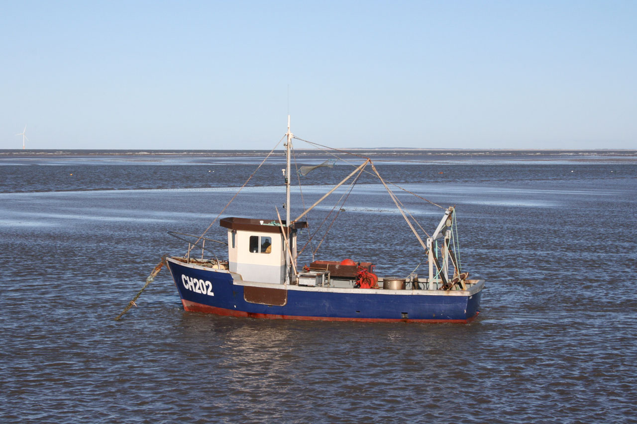 Little fishing boat moored at sea