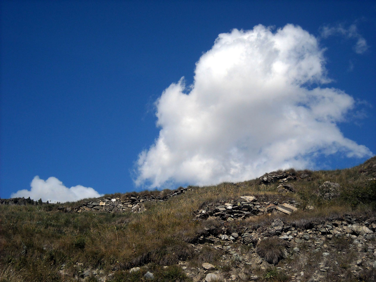Cloud on top of a mountain