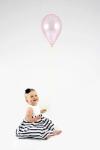 Baby Girl Holding Balloon