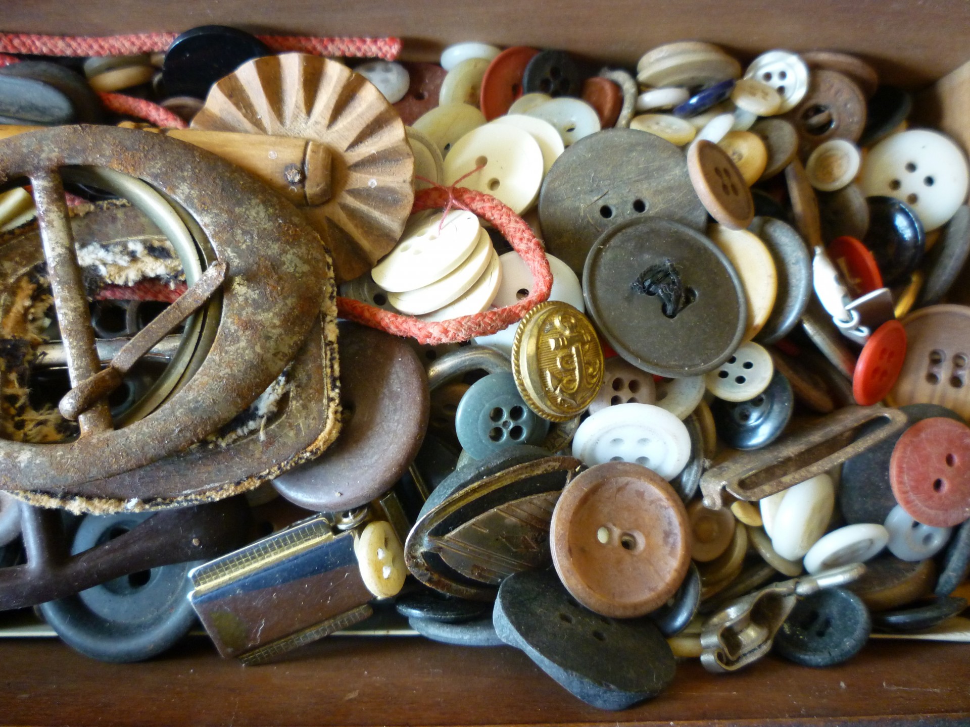 Old box containing buttons, buckles etc.