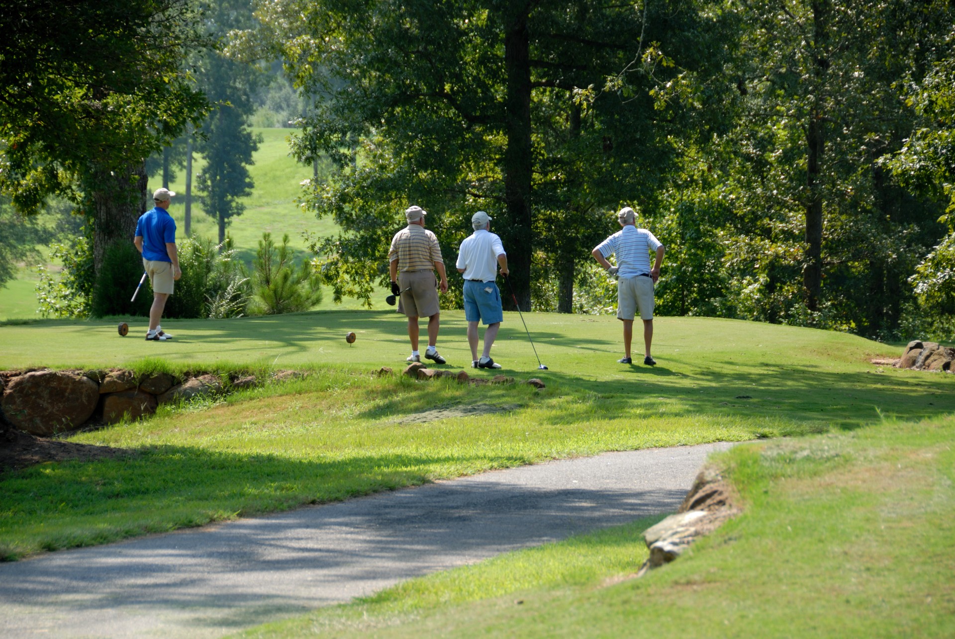 Golfers at golf course tee off
