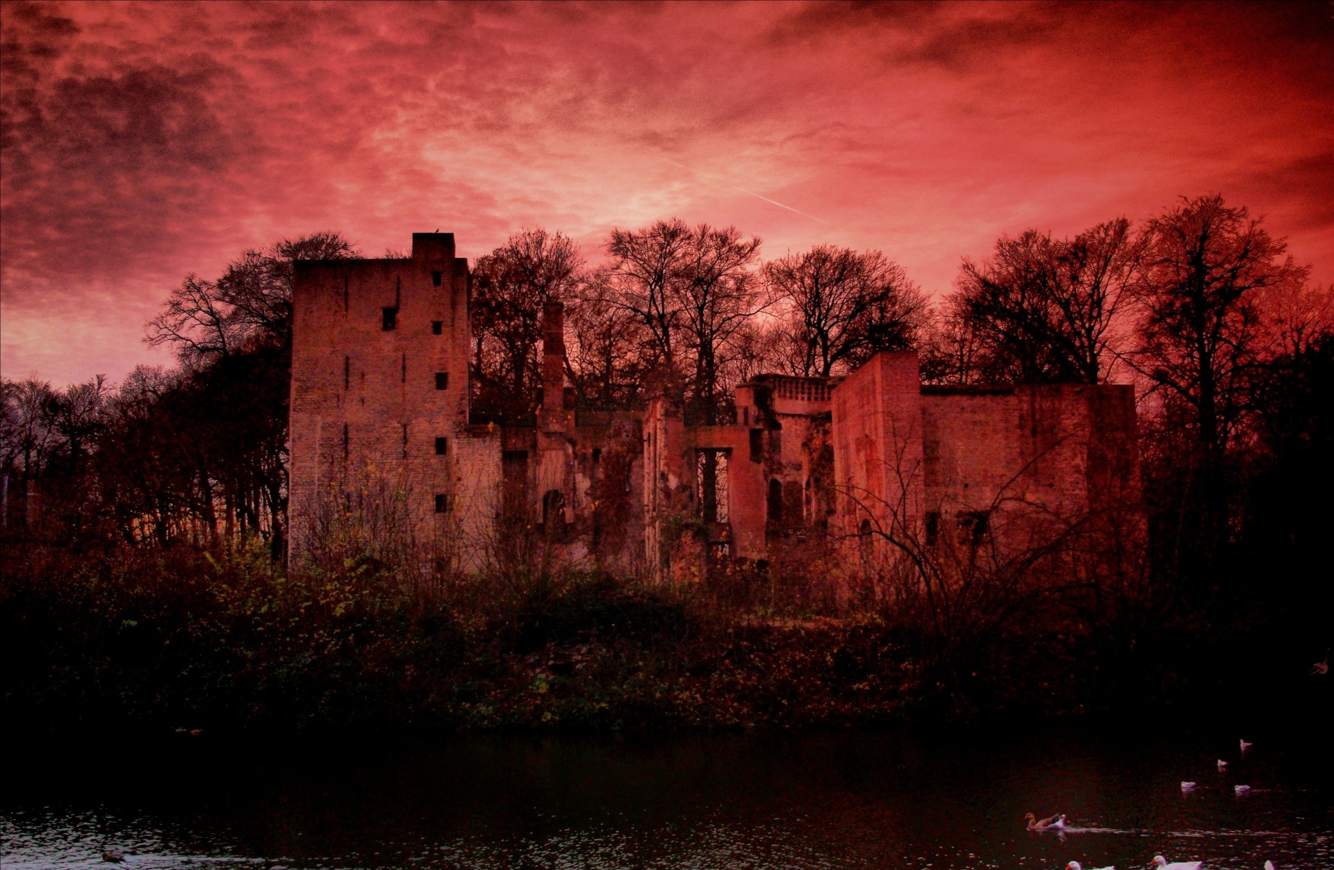 Spooky abandoned castle under a red sky