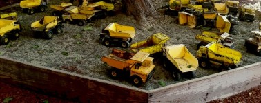 Sandbox Of Yellow Toy Trucks