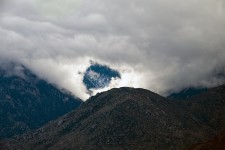 Snowy Peak Through The Clouds