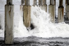 Wave Crashing On Pier Posts