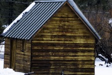 Wooden Cabin In Winter Snow