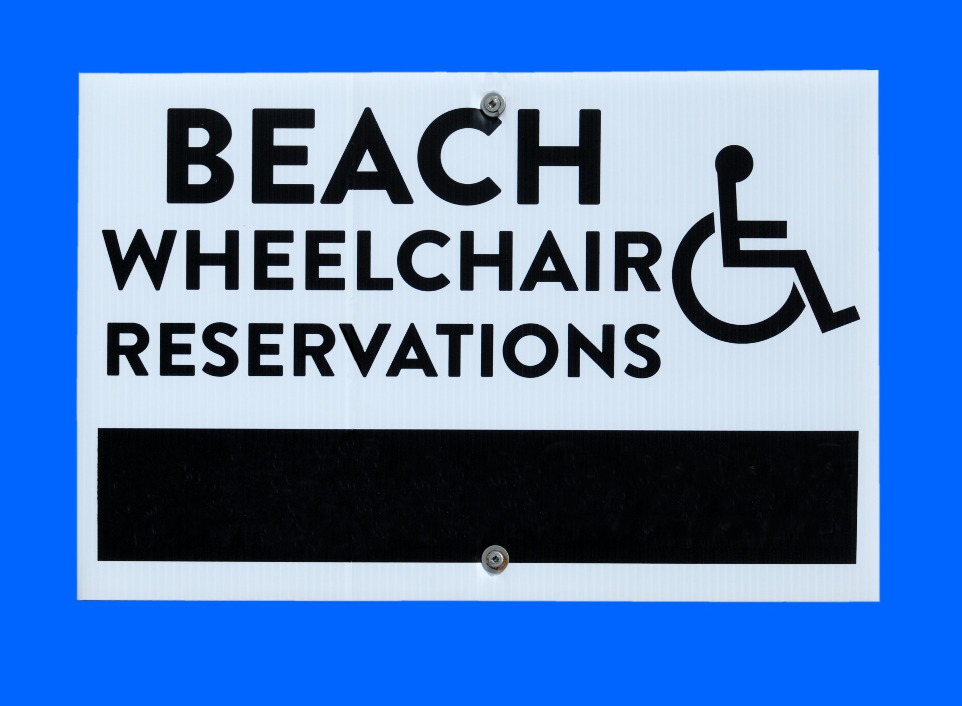 Beach Wheelchair rental sign at local beach Florida, USA.