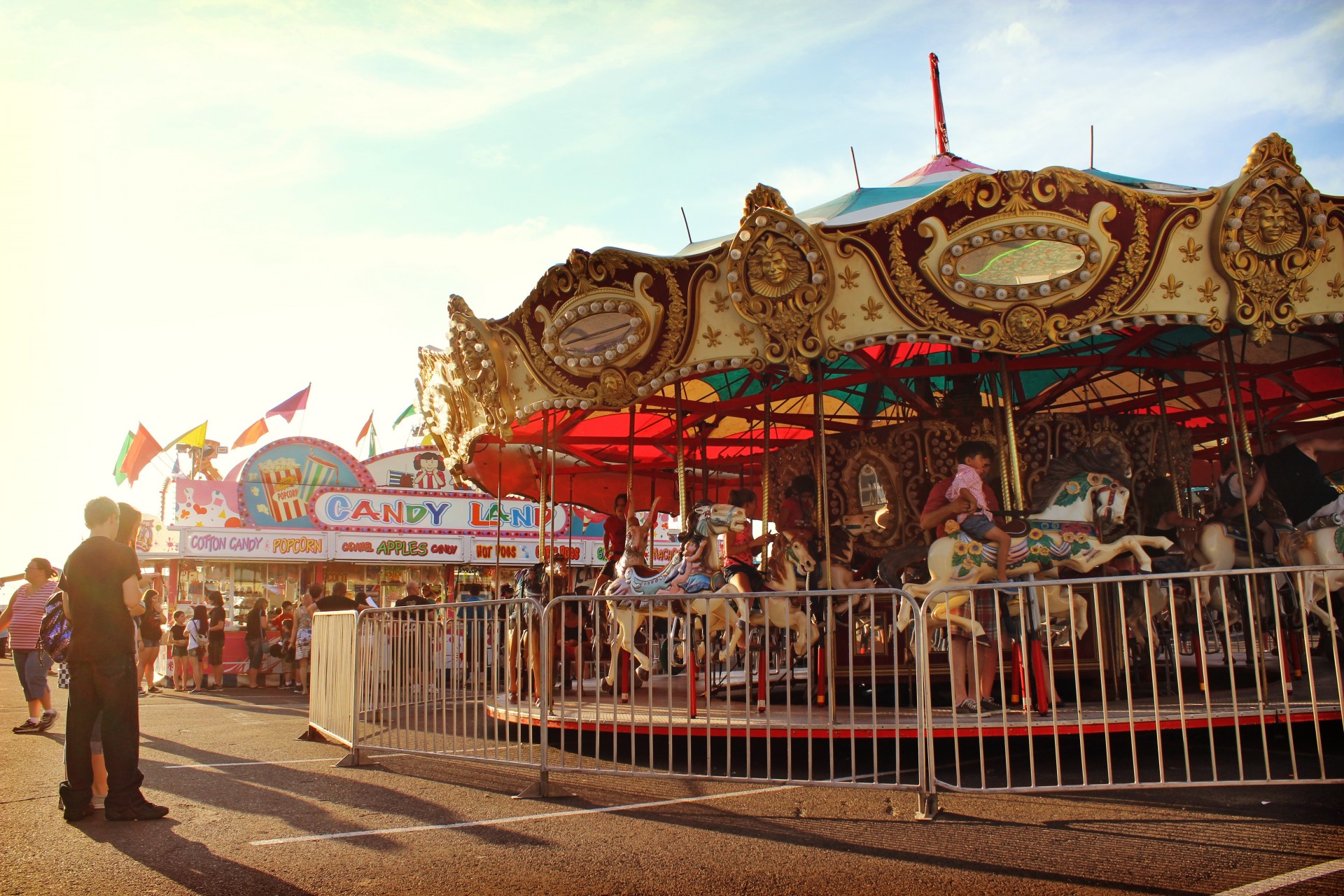 Carnival fairgrounds, people and rides.