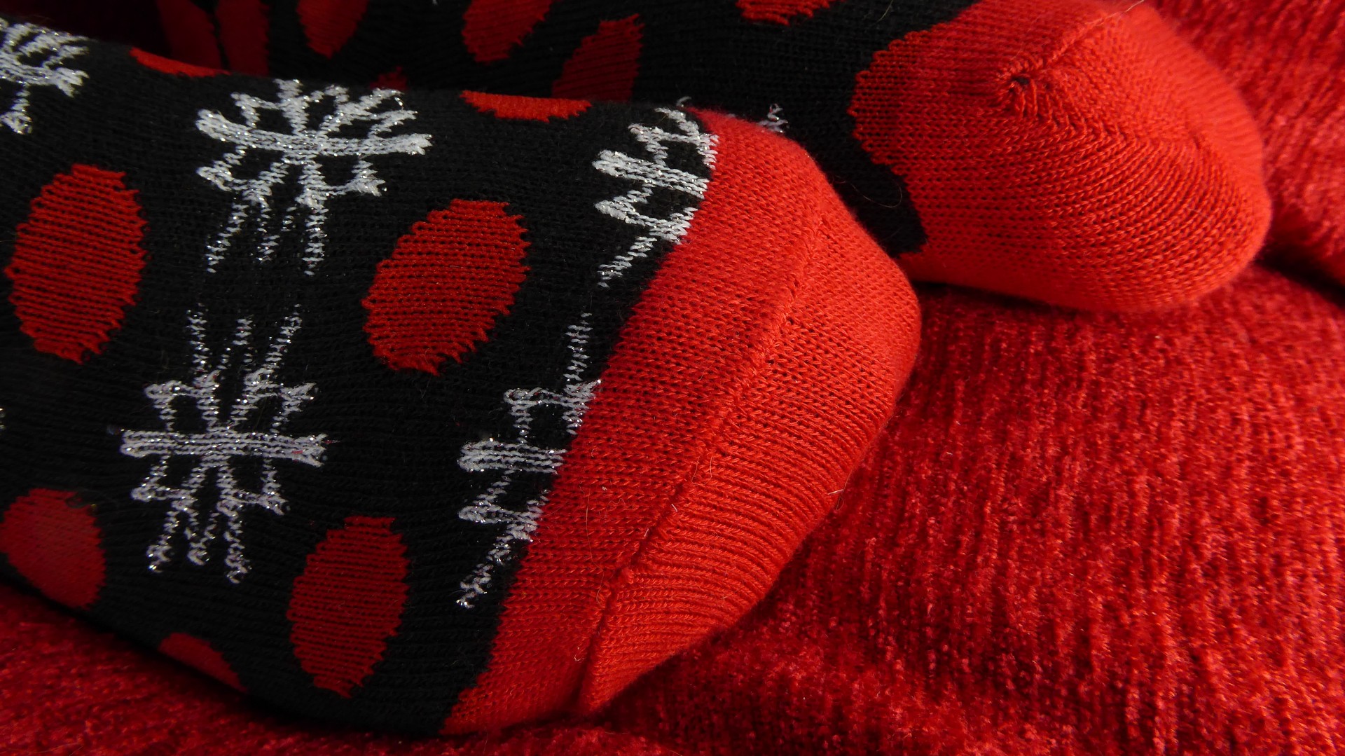 Christmas Socks On A Red Pillow