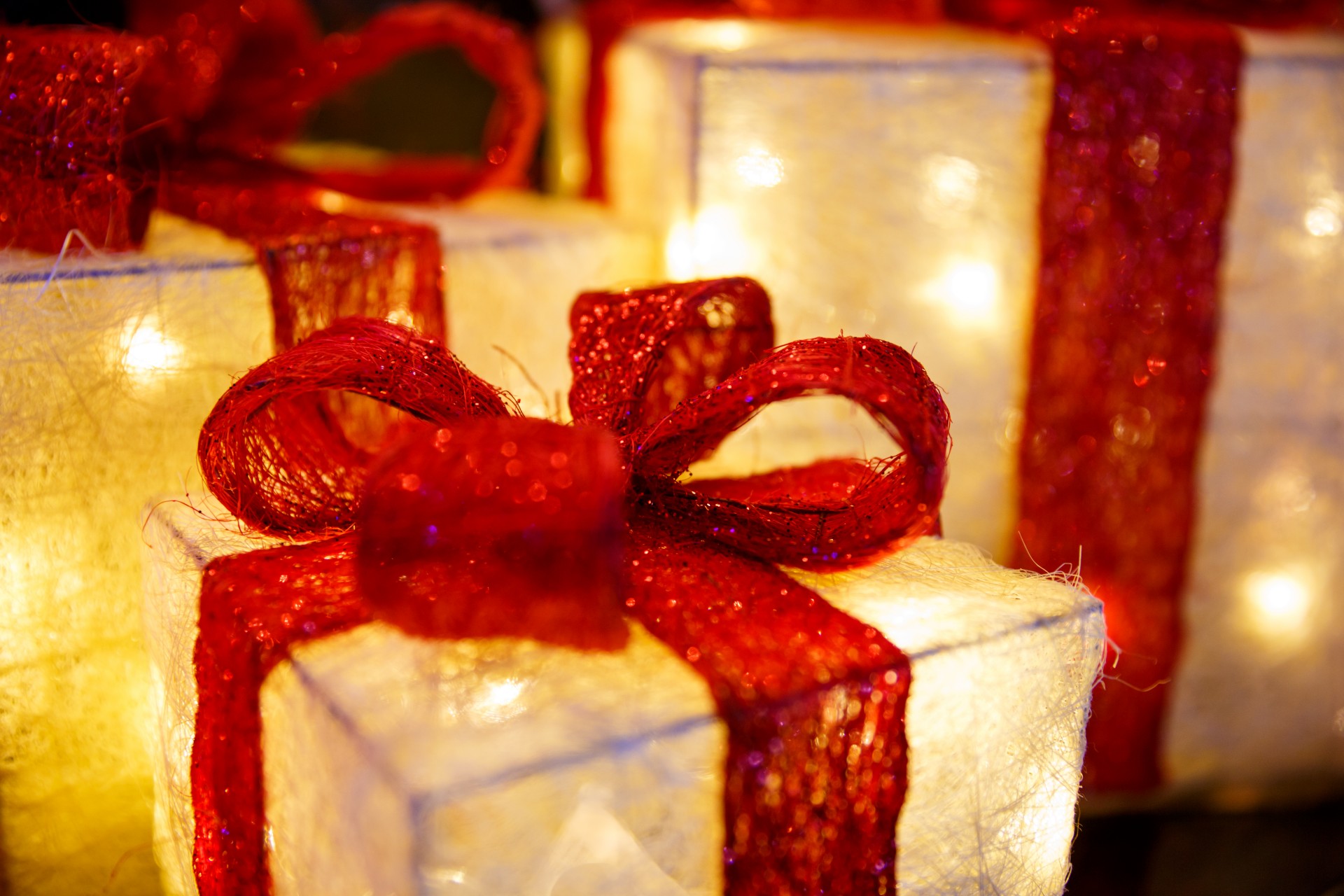 Illuminated christmas presents with red ribbon
