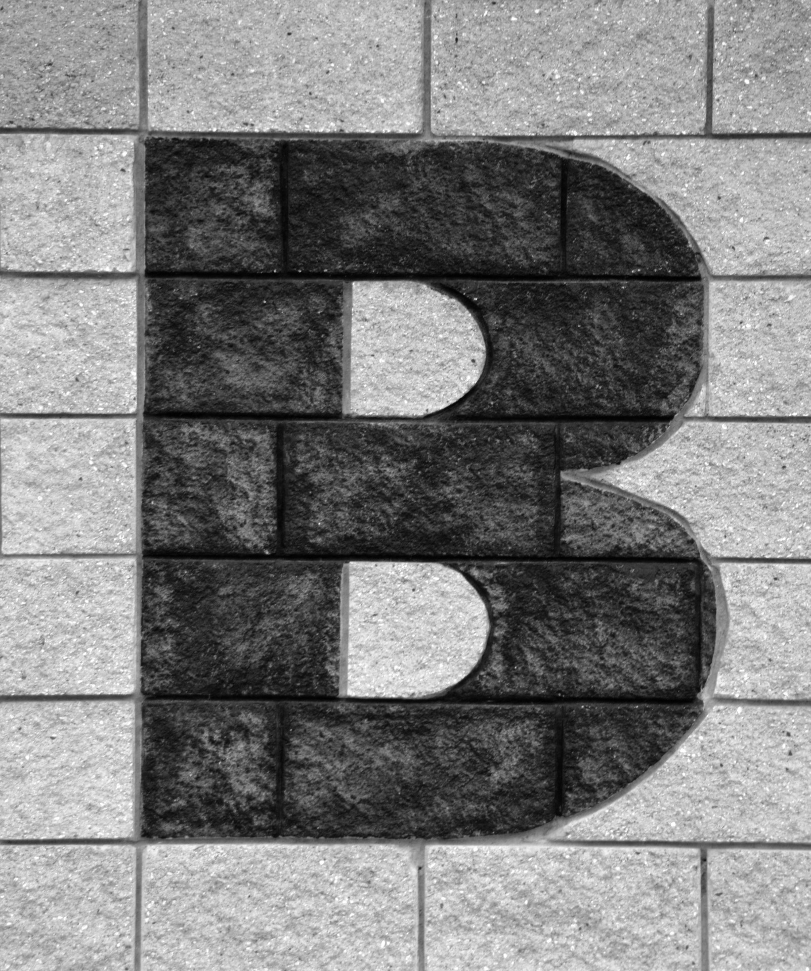 Letter B on brick wall of building exterior