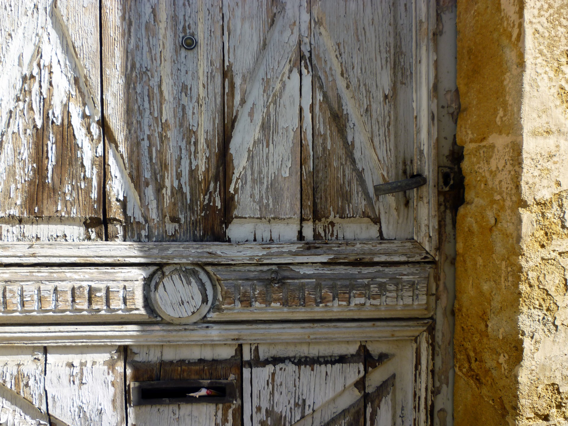 Old wooden door with peeling gray paint