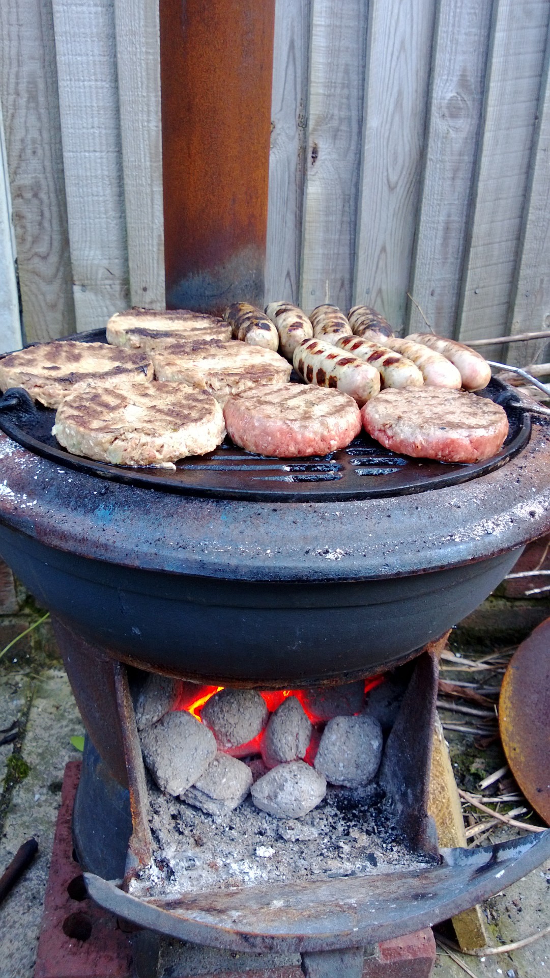 Cooking BBQ'd meat on an outdoor stove on charcoal