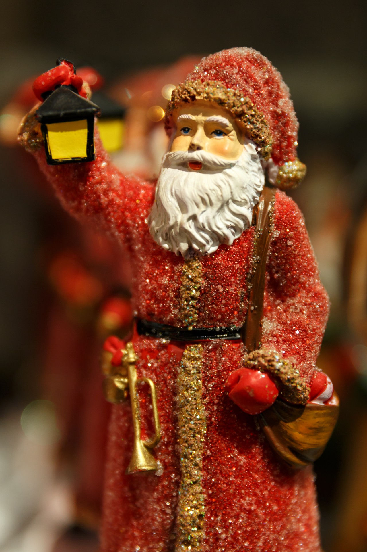 Santa Claus figure holding a lantern