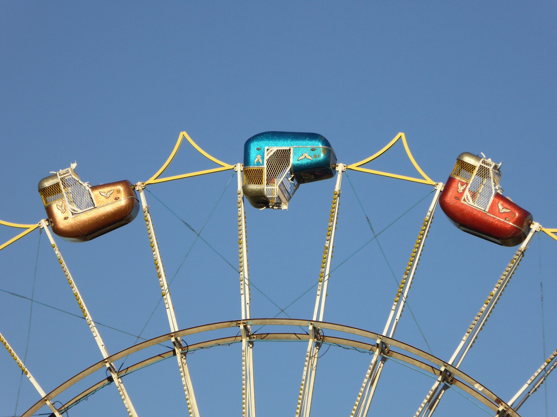 Metaphor for a bad day - a ferris wheel car upside down stuck at the top of a ferris wheel