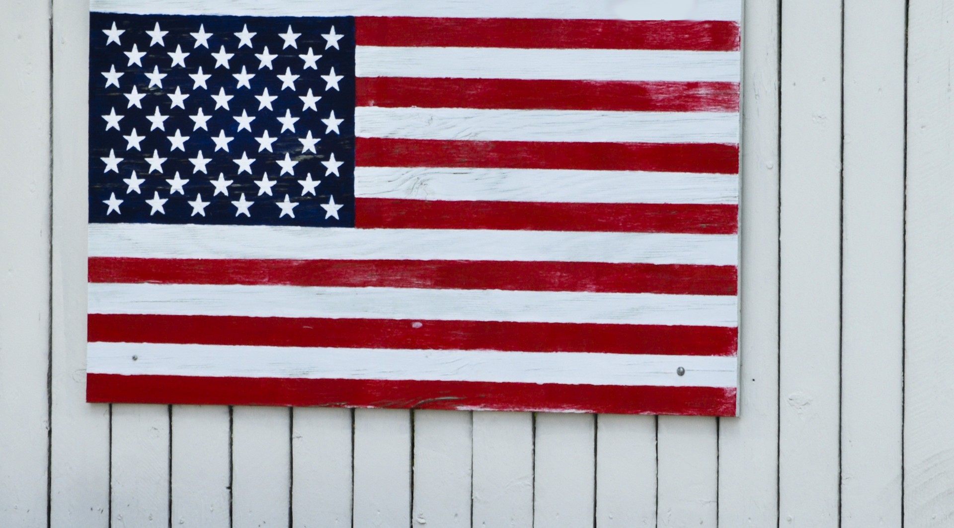 American Flag On White Fence