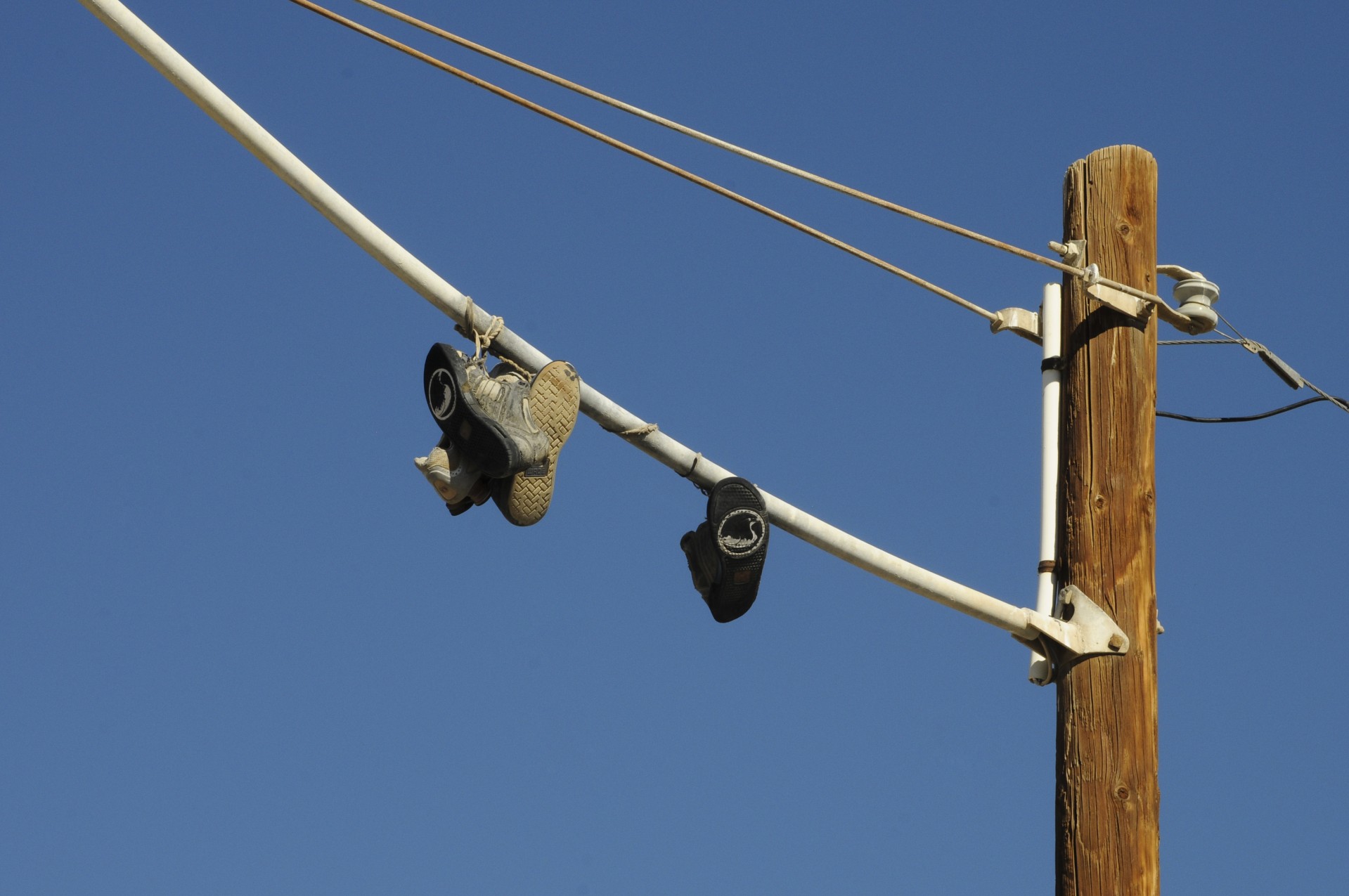 Slab City, California - shoes thrown over and now hanging from telephone pole wires