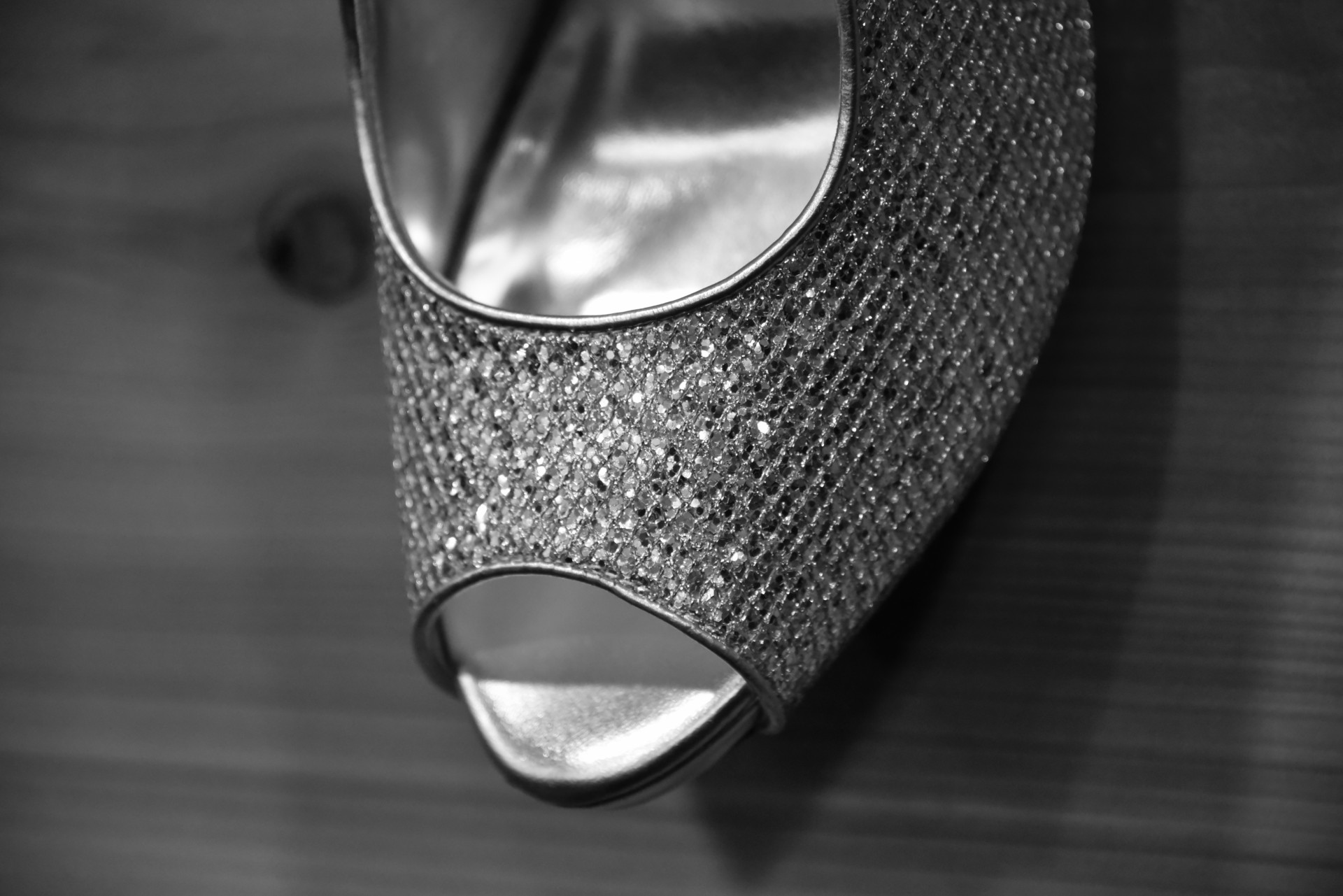 The toe of a woman's rhinestone heel dress shoe