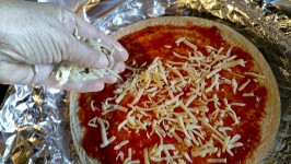 Adding Cheese To Homemade Pizza