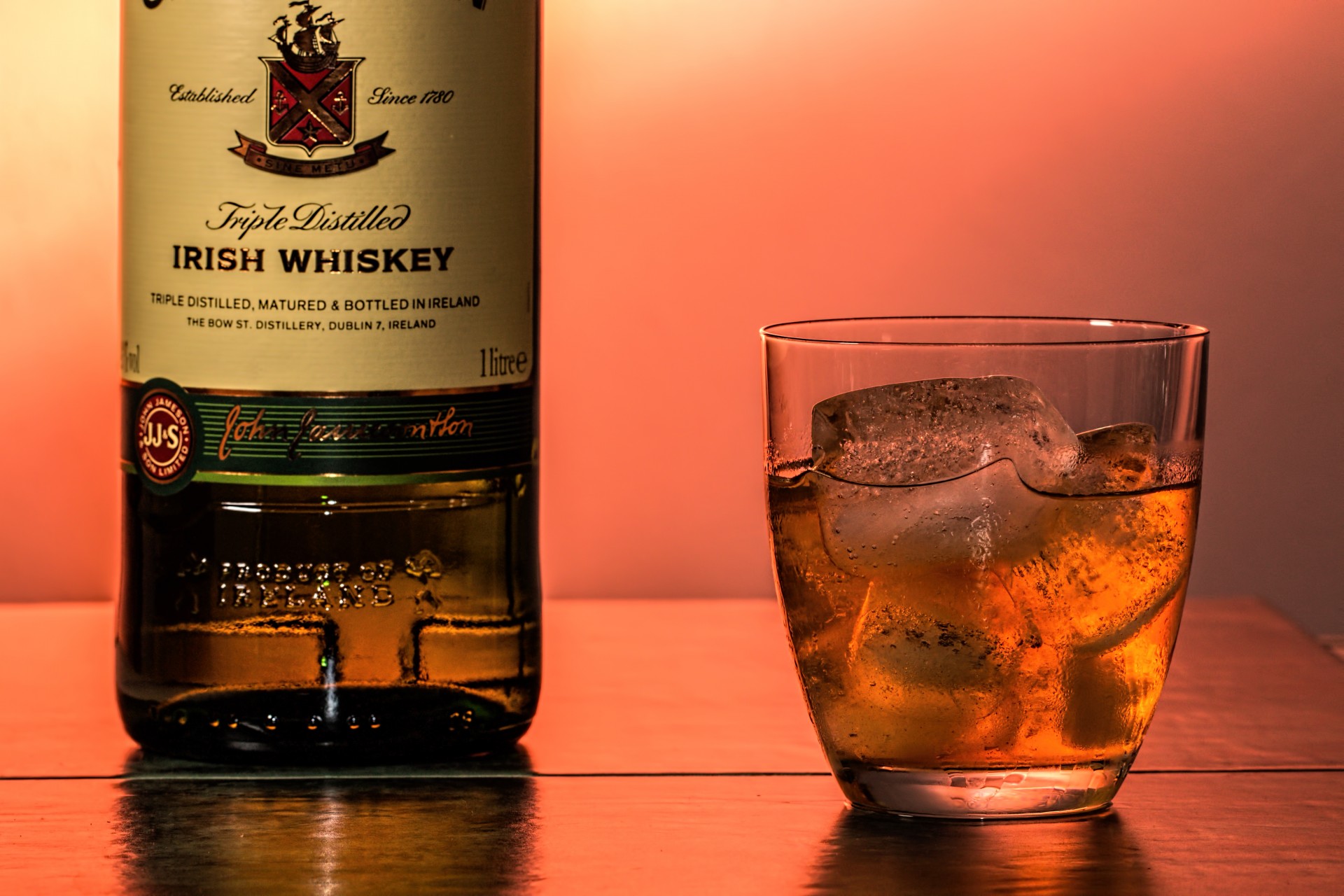 Tumbler of Irish Whiskey with bottle.