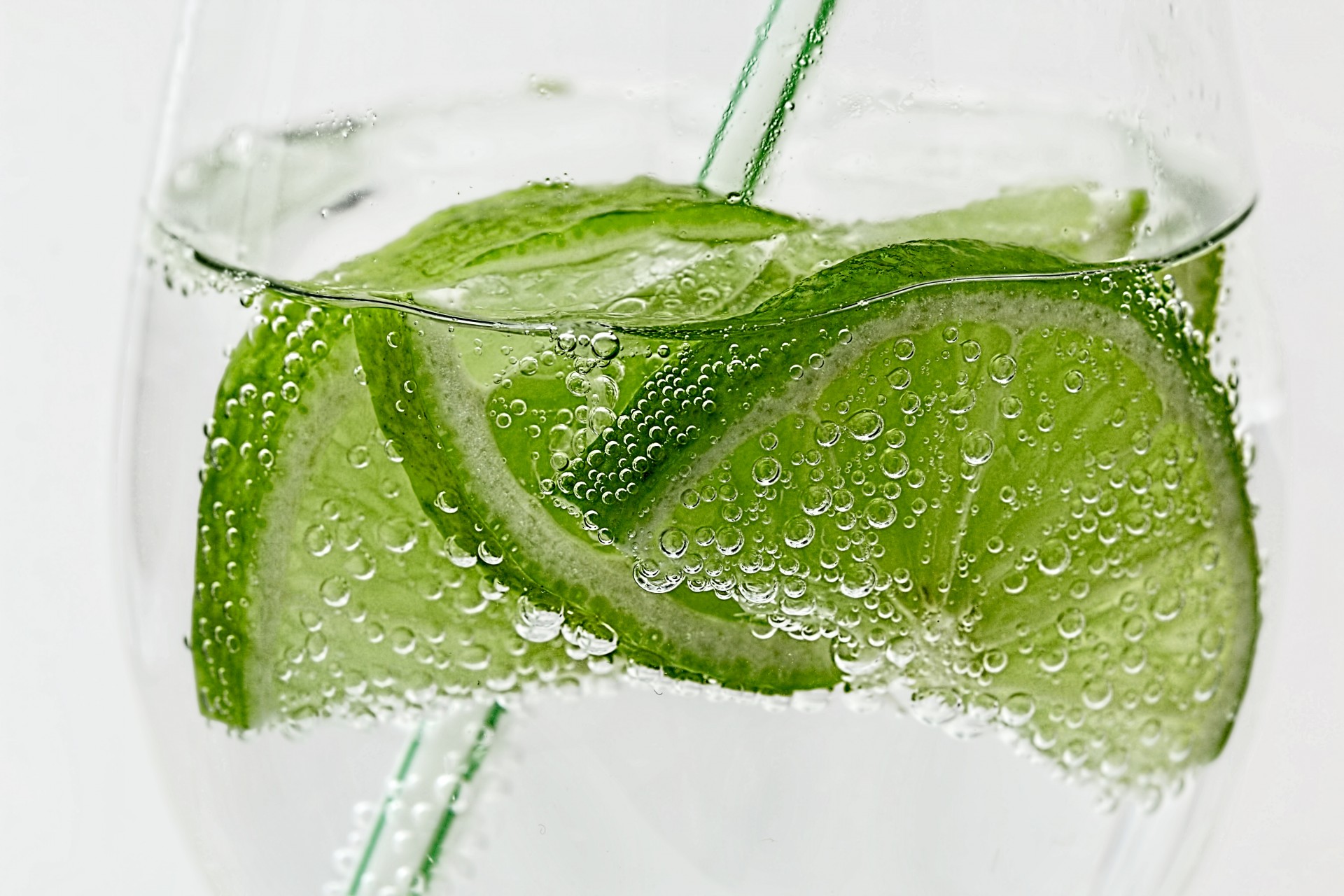 Sliced limes in a glass of club soda
