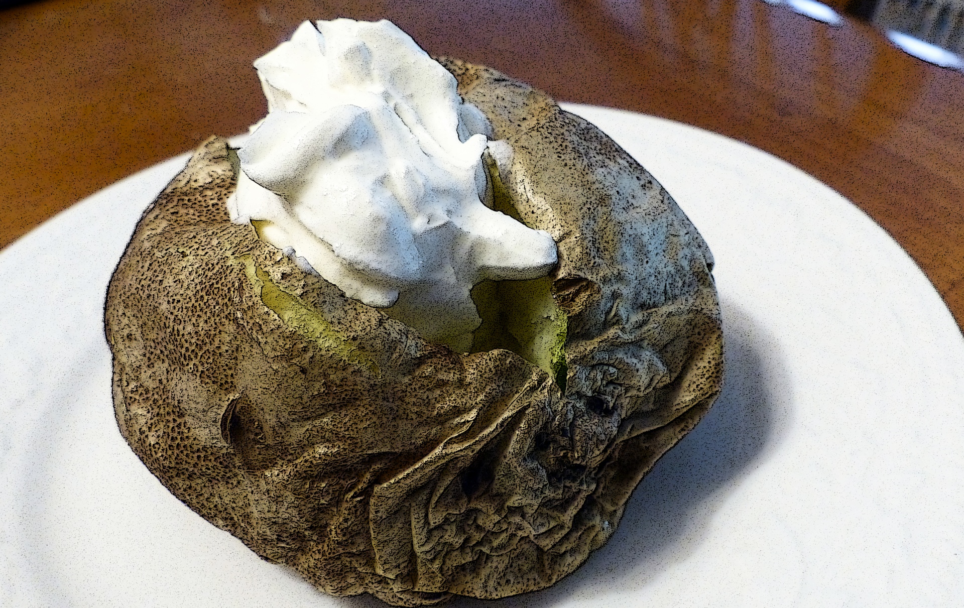 Baked potato and sour cream on a white plate