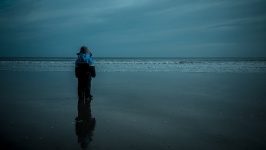 Boy Standing At Beach