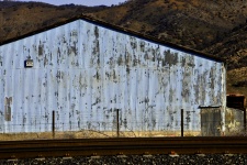 Grunge Building By Railroad Tracks