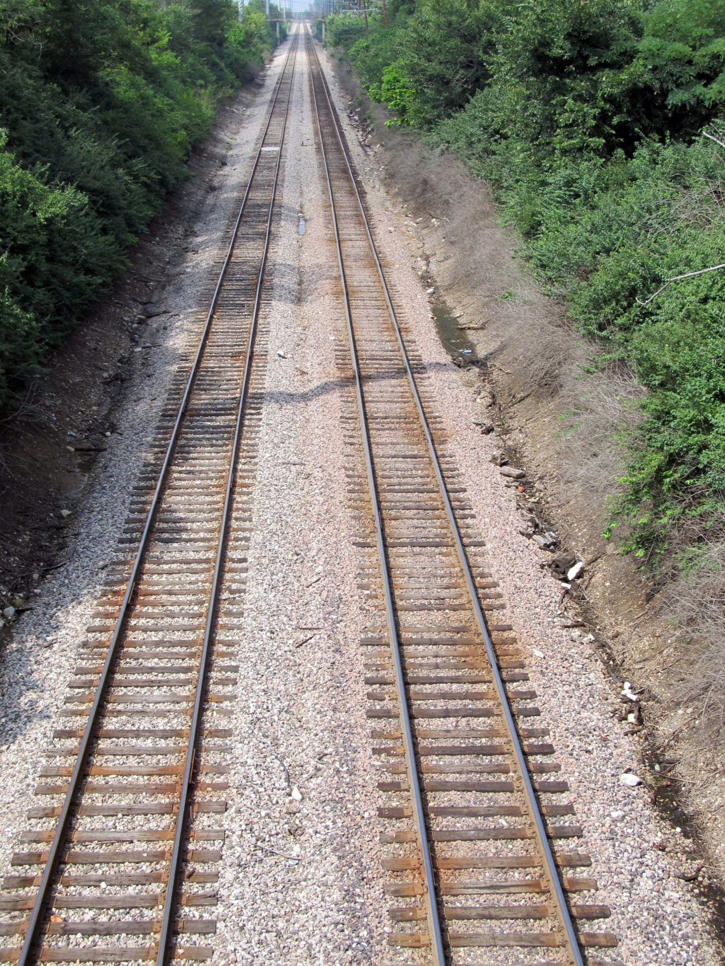 View looking down urban railroad tracks