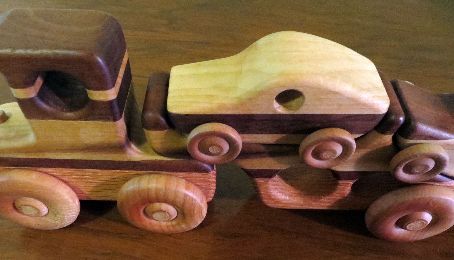 A handmade vintage wooden toy cars truck set carved in Ohio