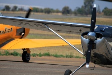 Silver Cessna Wing Crossing Yellow
