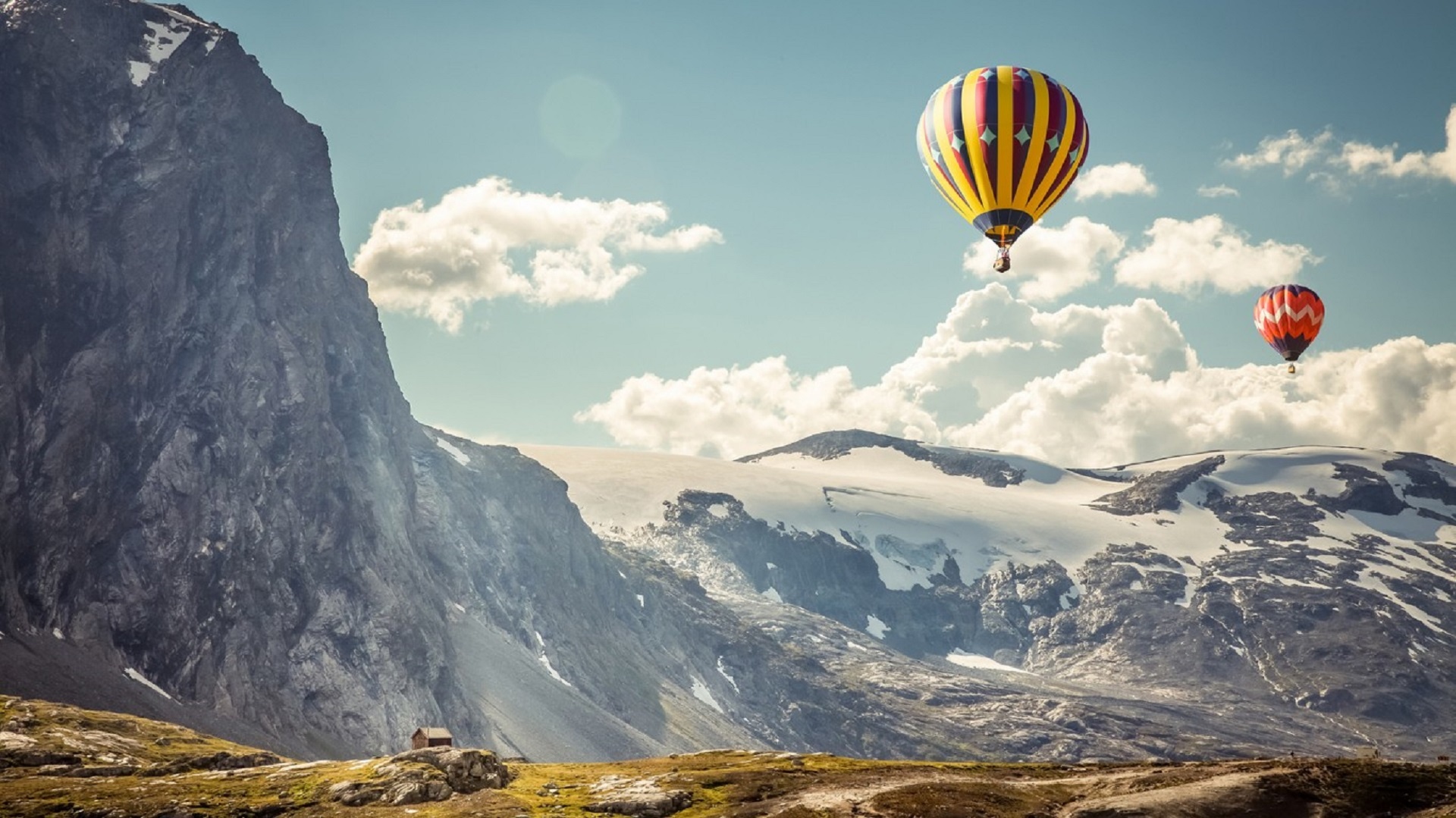 Hot Air Balloons floating through the mountains