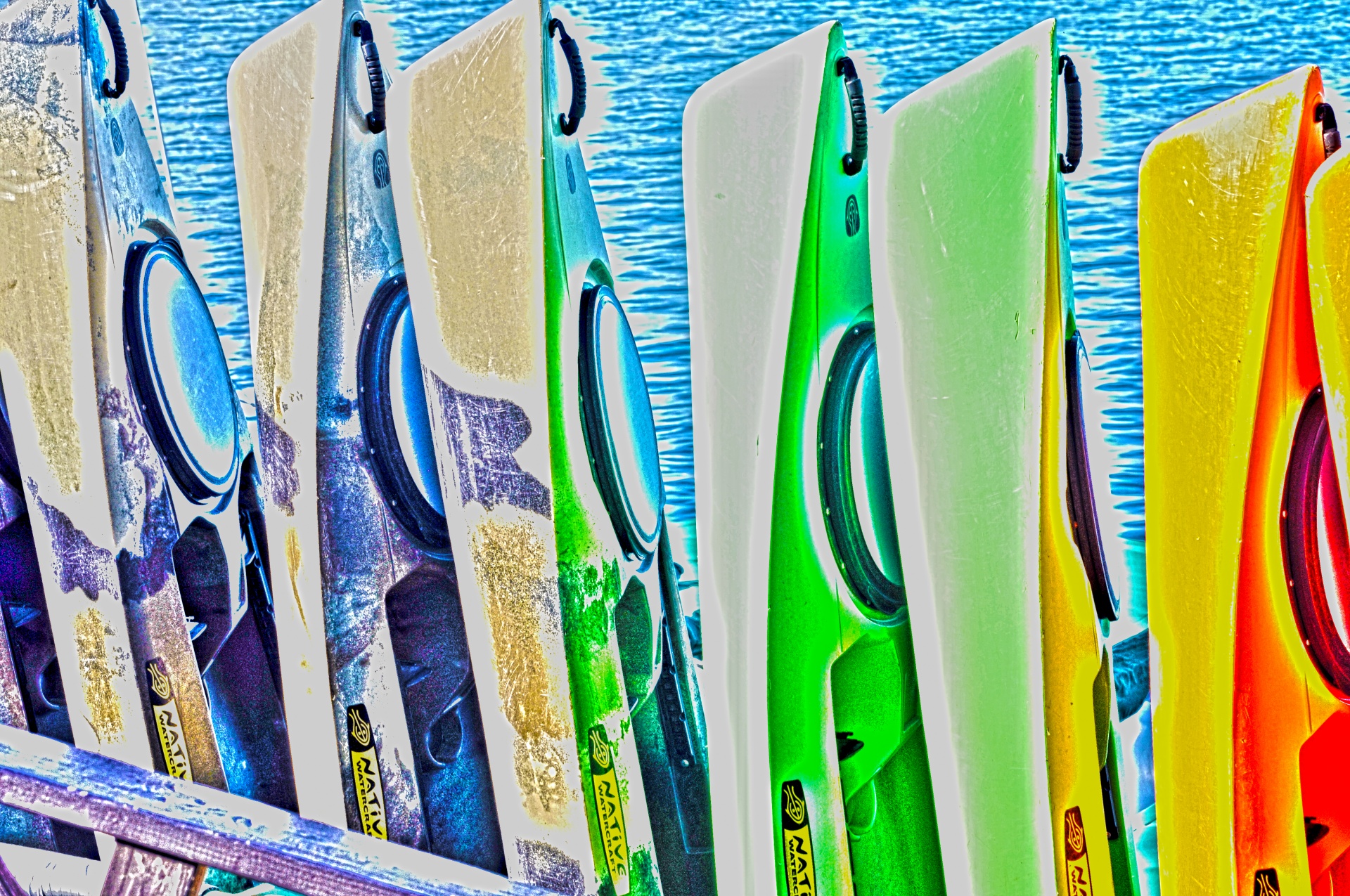 artistic effect added to photo pf a row of upright kayaks awaiting rental