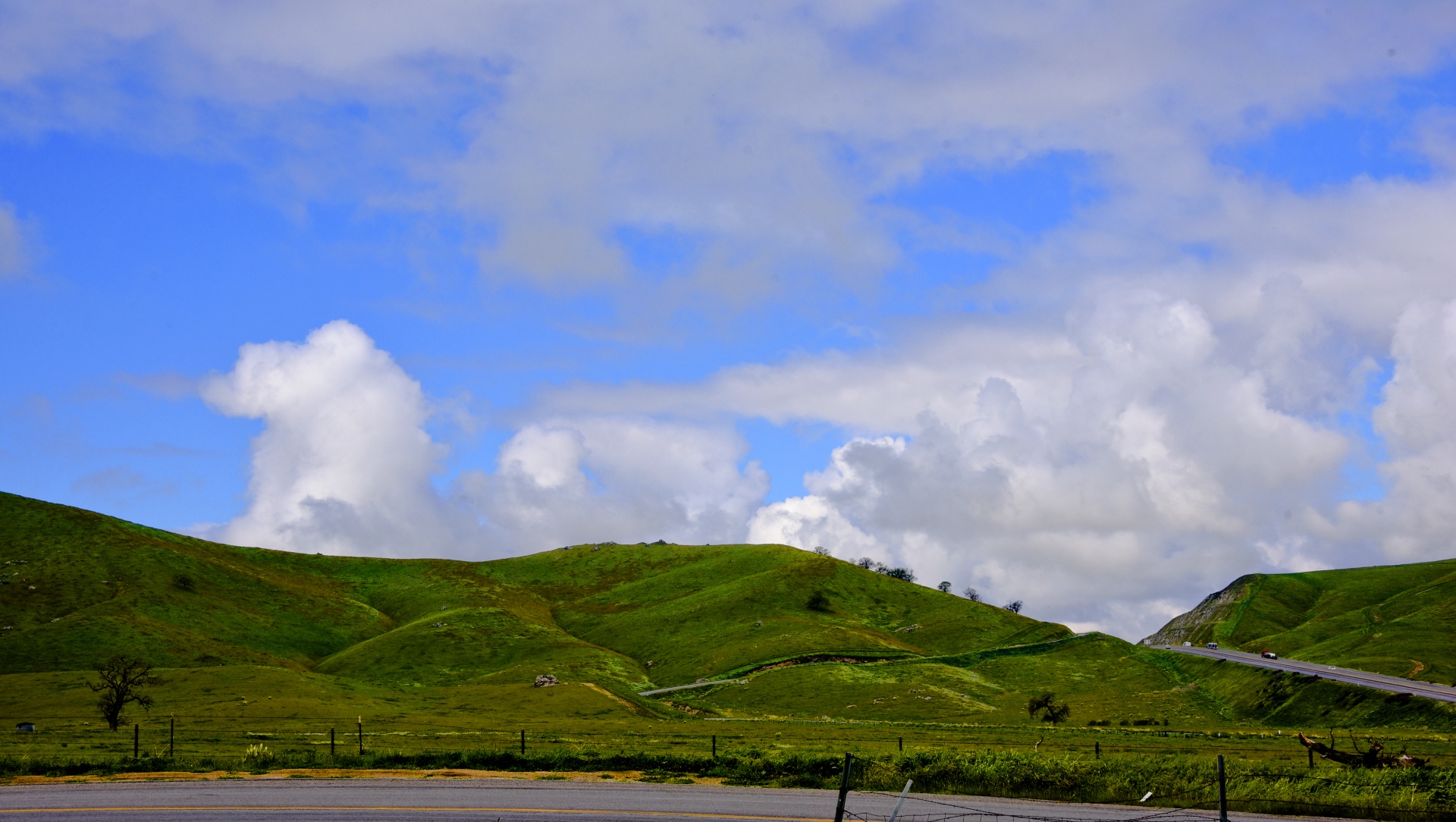 Green Hills And Cloudy Sky