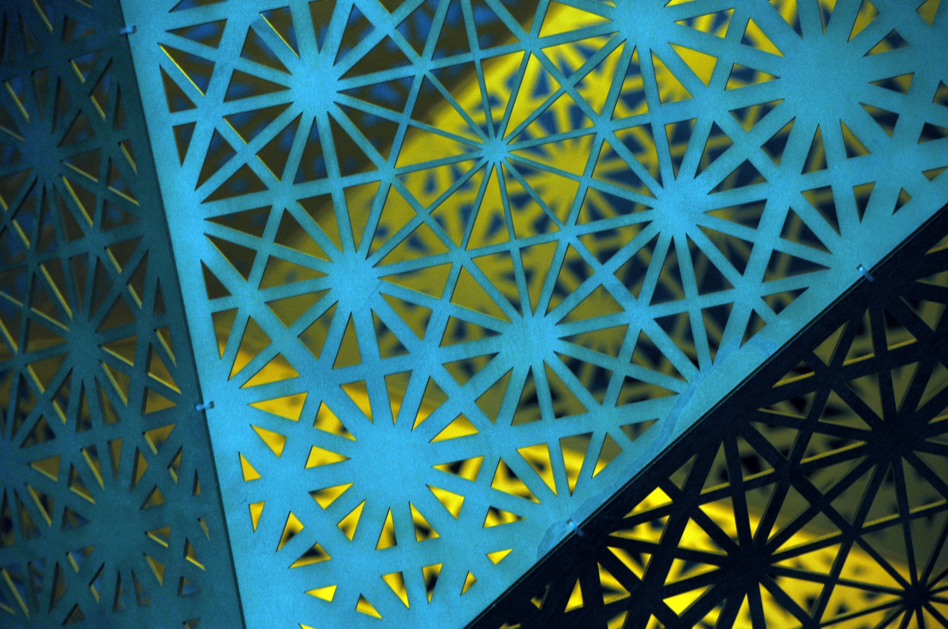 wallpaper of a metal starburst grid with blue back lighting