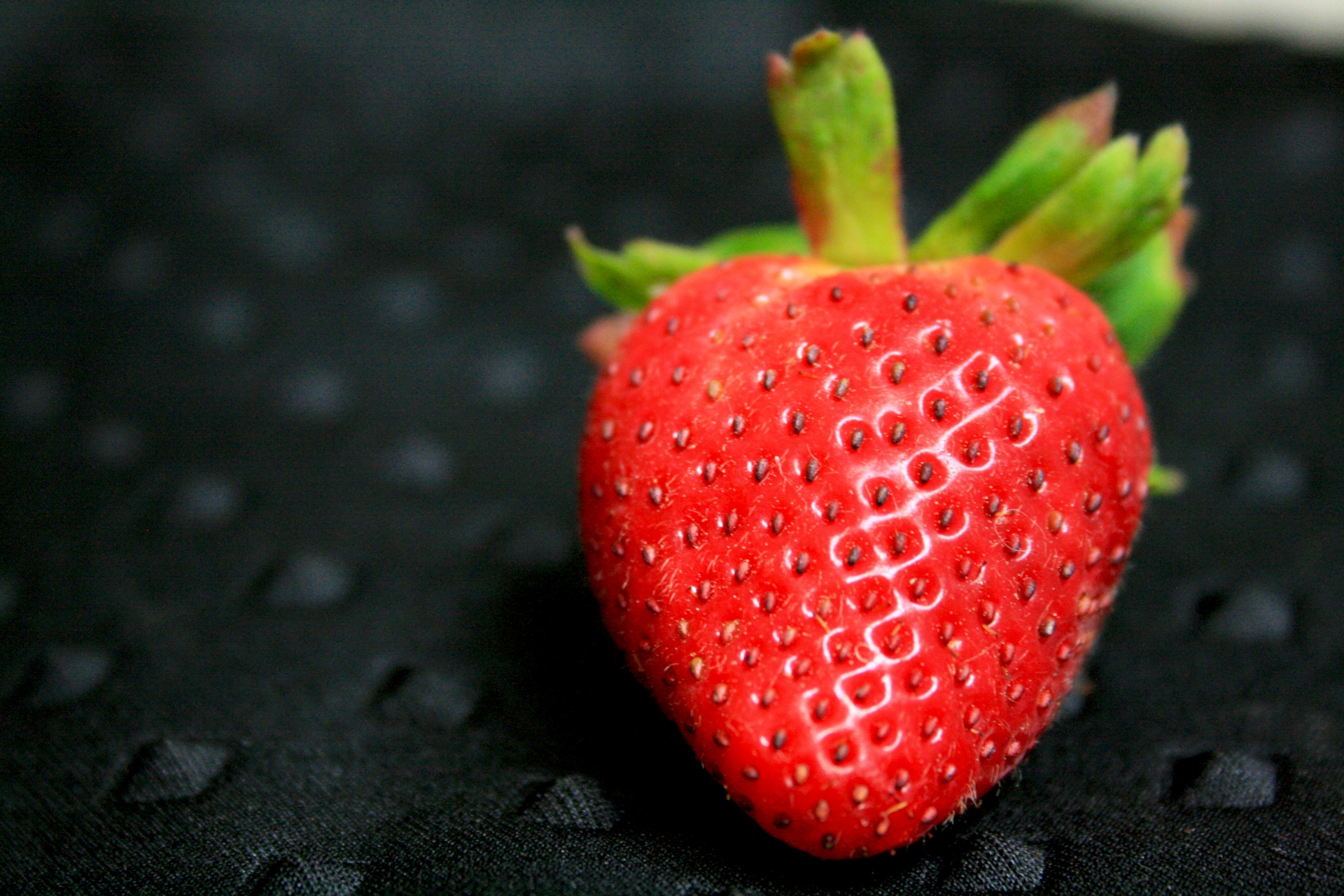 Macro of a bright red ripe strawberry.