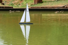 Model Sailboat On Pond