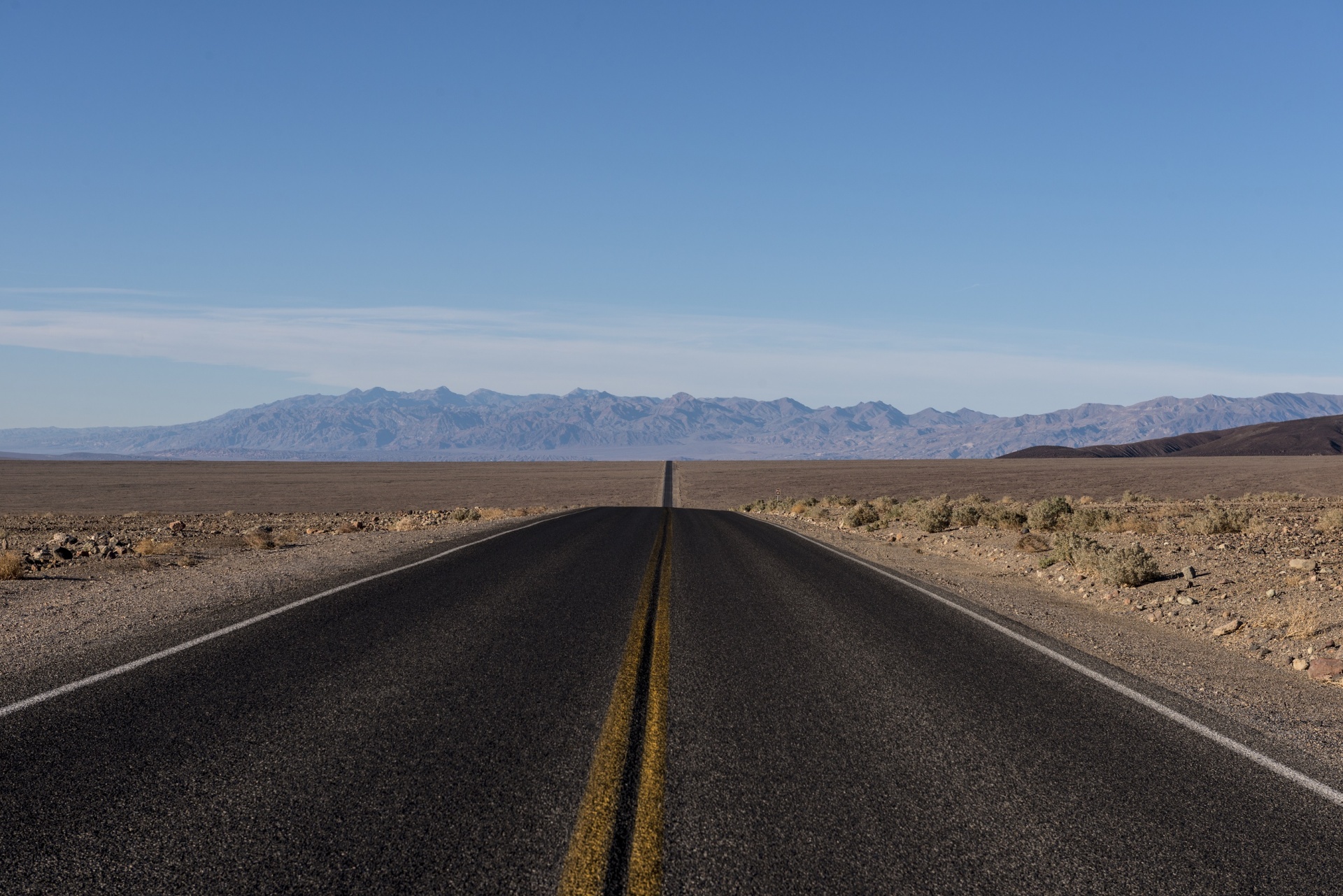 Straight blacktop highway through California's Death Valley desert