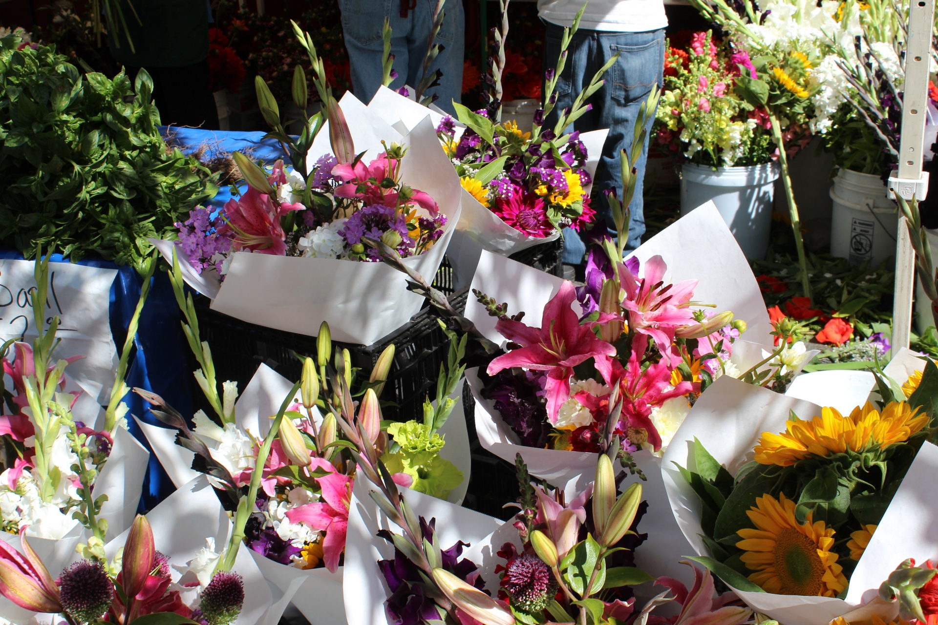Farmers' Market vendor stand with an assortment of fresh flowers for sale