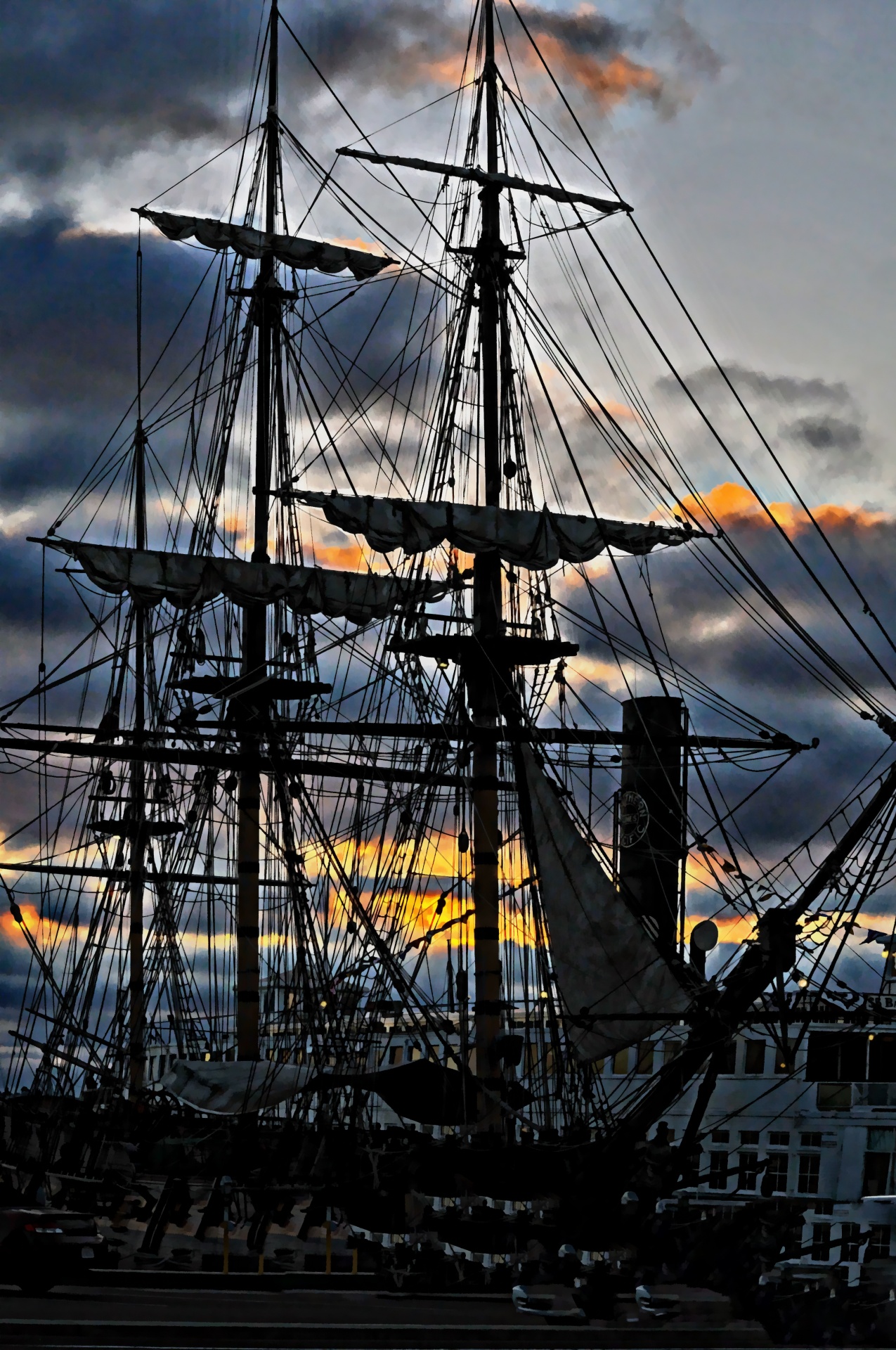 old sailing vessel docked in setting sun