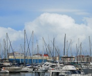 Masts Of Yachts Against Cloudy Sky