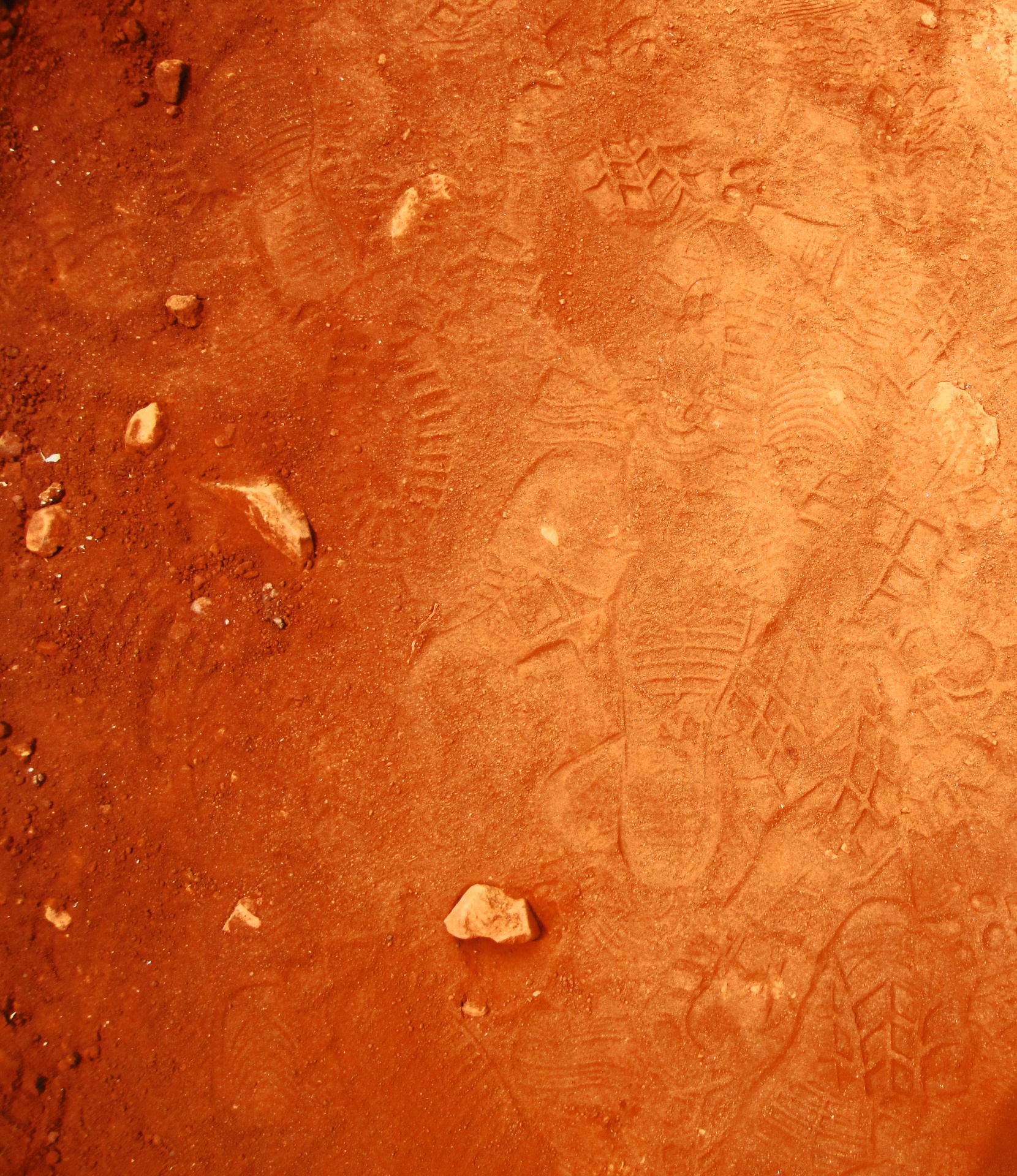 Bootprints In Loose Red Soil
